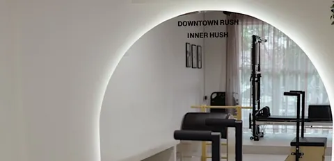 An arched alcove in the studio, lit from behind, with equipment beyond it
